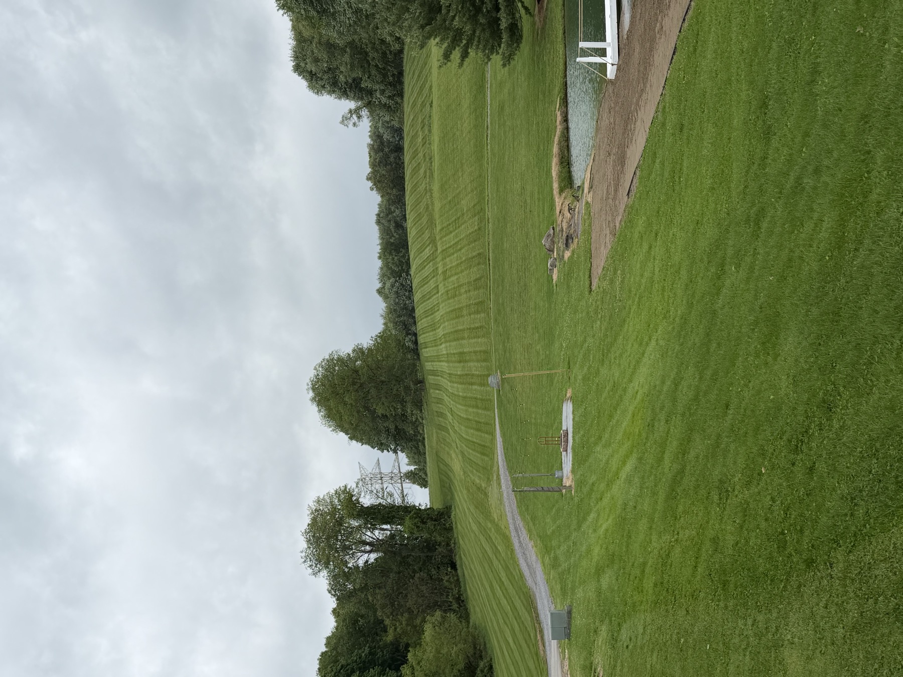Mowed lawn beside a pond