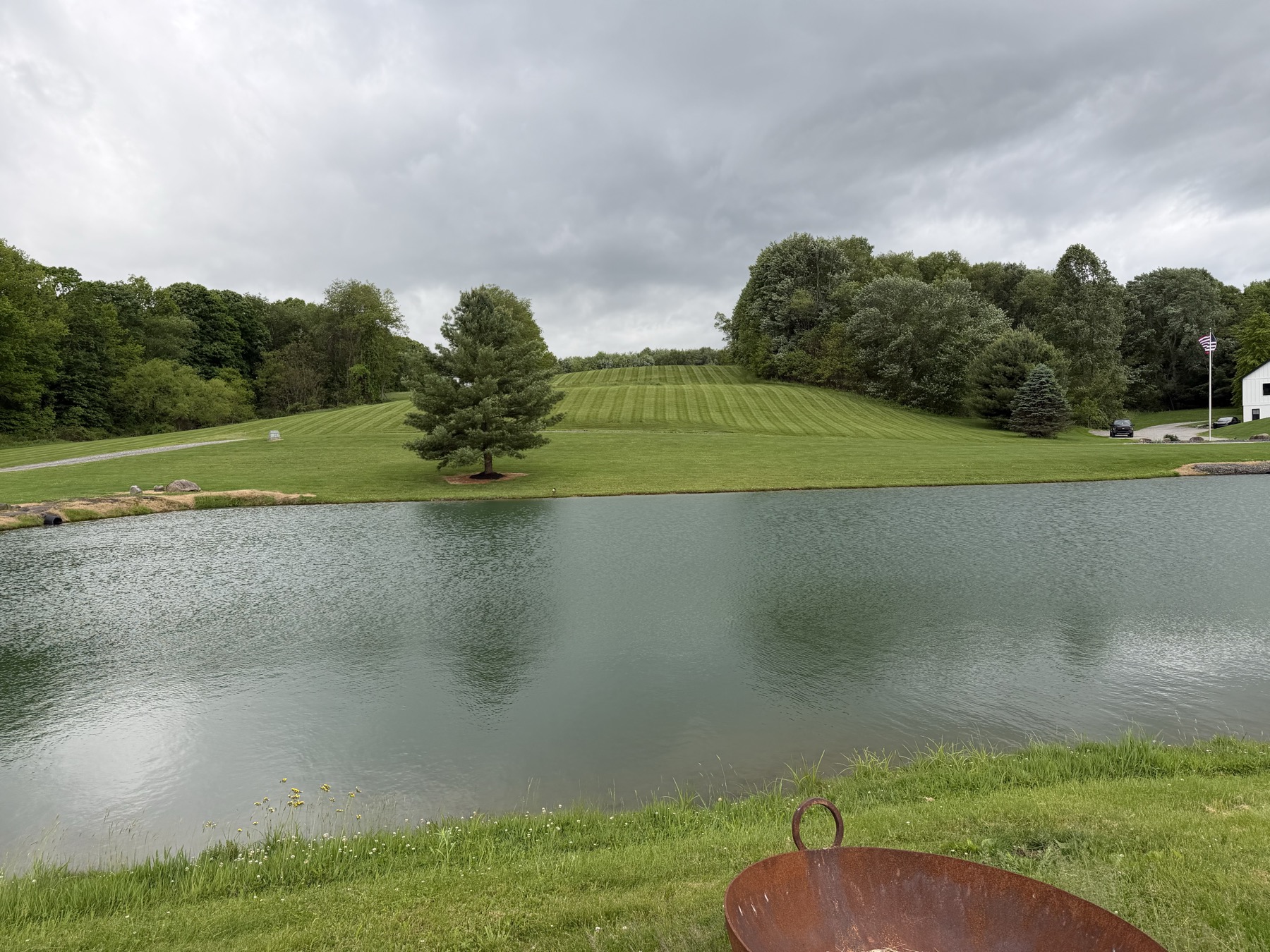 Pond-side mowing and striped hillside