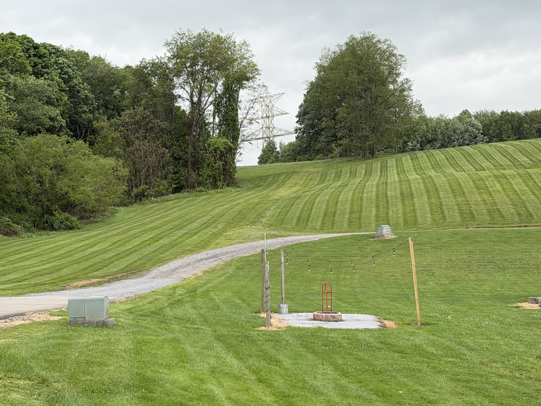 Striped hillside near a gravel drive