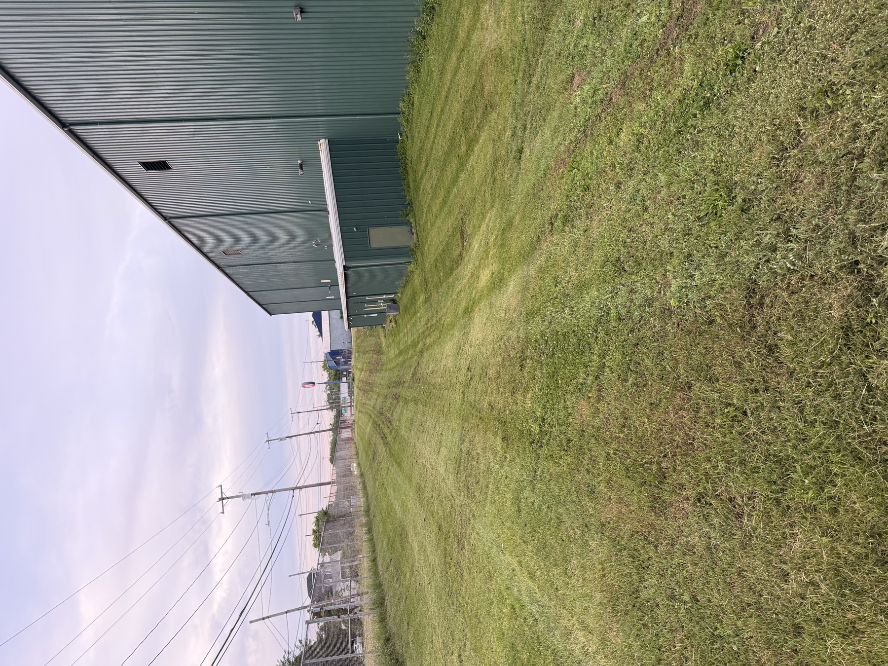 Mowed grass beside a commercial building