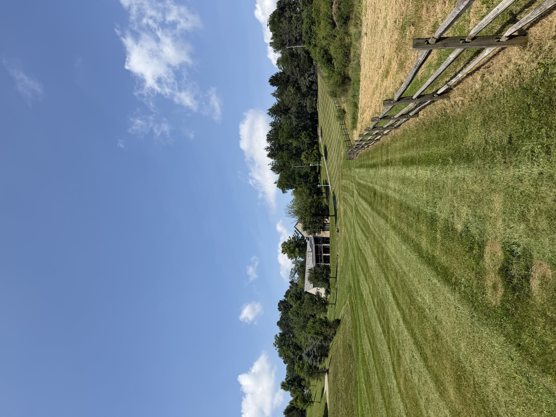 Lawn stripes along a fence line